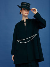 A lady with a pearl necklace and a black dress attends a masquerade party.